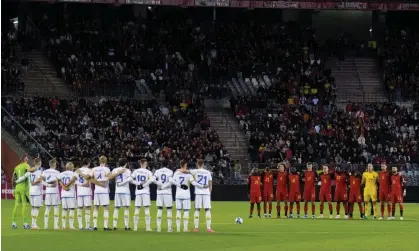  ?? ?? Belgium and Sweden players observe a one-minute silence before the match at the King Baudouin Stadium. Photograph: Soccrates Images/Getty Images