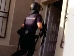 ??  ?? Prepared: An armed officer enters the building