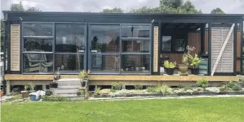  ?? ?? Now with the wheels removed and fully consented, Perry has added an outdoor living areaconser­vatory which she uses every day. IMage: NZ TINY HOMES.