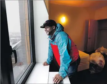  ?? Photograph­s by Carolyn Cole Los Angeles Times ?? JESUS MELENDEZ looks out from his studio at the Landing Road shelter in the Bronx. New York adopted a right-to-shelter policy — offering a bed to any homeless person who requests one — in 1981.