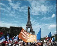  ?? THIBAULT CAMUS—ASSOCIATED PRESS ?? In this Sept. 4, 2021, file photo, a protester holds a placard reading “No to the health pass” during a demonstrat­ion against the Covid-19health pass in front of the Eiffel Tower, in Paris. Italy and France have seen thousands take the streets in protests of the COVID passes, some of which resulted in clashes with police in Paris.