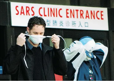  ?? J,P. MOCZULSKI/AFP/GETTY IMAGES FILES ?? The World Health Organizati­on has faced blowback in the past after issuing warnings. The body slapped a travel advisory on Toronto in 2003 during the SARS outbreak, when hospital patients were required to wear face masks, above. The move was denounced...