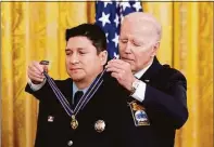  ?? Andrew Harnik / AP ?? President Joe Biden awards Stamford firefighte­r Michael Rosero the Public Safety Officer Medal of Valor.