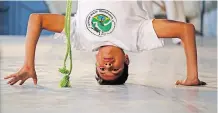  ??  ?? A Capoeira Ache Brasil member displays martial arts skills.