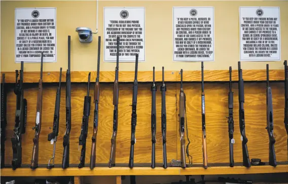  ?? Photos by James Tensuan / Special to The Chronicle ?? Guns are displayed at High Bridge Arms in the Mission District. The store is closing at the end of October as a supervisor seeks to toughen S.F.’s weapons laws.