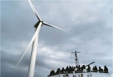  ?? DAVID GOLDMAN/AP ?? Guests tour one of the turbines of America’s first offshore wind farm, owned by the Danish company Orsted, on Oct. 17 off the coast of Block Island, R.I. A new poll shows many think not enough is being done to fight climate change.