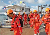  ?? — AFP ?? A Chinese rescue team arrives at Chalong pier in Phuket in Phuket, Thailand, on Sunday.