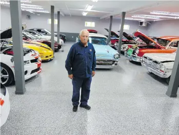  ?? ALYN EDWARDS ?? Garry Cassidy stands in the newly rebuilt shop with some of the collector cars replacing those lost in last year’s fire on his Langley property.