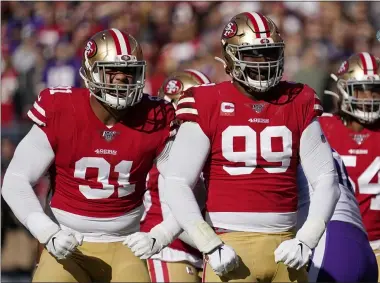  ?? TONY AVELAR — THE ASSOCIATED PRESS ?? 49ers defensive end Arik Armstead, left, and defensive tackle DeForest Buckner react to a play against the Vikings during the first half of a divisional playoff game Jan. 11 in Santa Clara, Calif.