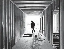  ?? [ERIC ALBRECHT/DISPATCH] ?? A visitor walks through a shipping container.