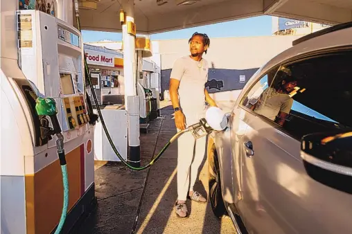  ?? NOAH BERGER/ASSOCIATED PRESS ?? A motorist fills up at a Shell station Monday in San Francisco, where regular unleaded gasoline was selling for $5.85 per gallon. President Joe Biden on Tuesday ordered 50 million barrels of oil released from America’s strategic reserve to help bring down energy costs, in coordinati­on with other major energy consuming nations, including India, the United Kingdom and China.