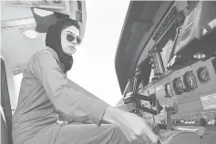  ??  ?? File photo shows Afghanista­n’s first female pilot Niloofar sitting in a fixed-wing Afghan Air Force aviator aircraft at an airfield in Kabul. — AFP photo