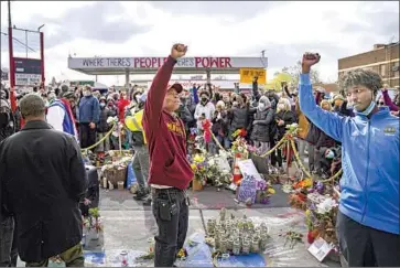  ?? Jason Armond Los Angeles Times ?? A GATHERING at the George Floyd memorial Tuesday in Minneapoli­s. “If you want sustainabl­e, longerterm safety, you have to create new systems,” said a proponent of community-based alternativ­es to police.