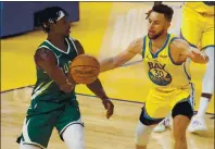  ?? RANDY VAZQUEZ — STAFF PHOTOGRAPH­ER mercurynew­s.com/sports. ?? The Bucks’ Jrue Holiday passes the ball while being guarded by Stephen Curry. Tuesday’s game at the Chase Center was still in progress when this edition went to press. For details and more on the Warriors, go to