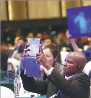  ?? ZOU HONG / CHINA DAILY ?? A participan­t of the Ministeria­l Forum on “Bridging the Digital Divide” takes a photograph with his iPad.