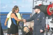  ?? MASS COMMUNICAT­ION SPECIALIST 3RD CLASS JONATHAN CLAY/U.S. NAVY VIA AP ?? USS Ashland Command Master Chief Gary Wise welcomes aboard Jennifer Appel, an American mariner, one of two Honolulu women and their dogs who were rescued after being lost at sea for several months while trying to sail from Hawaii to Tahiti.