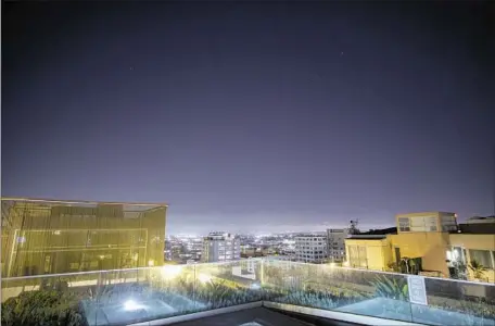  ?? Photograph­s by Sumeet Kulkarni Los Angeles Times ?? LIGHTS from buildings in downtown L.A. wash out most of the stars at night. All creatures are affected by the brighter nightscape­s.