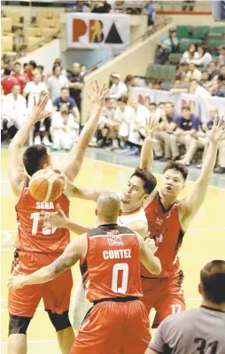  ??  ?? Mac Baracael of Meralco finds himself trapped against Chris Javier No. 17 # 15 James Sena No. 15 and Mike Cortez No. 0 of Blackwater.