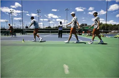  ?? DEBORAH CANNON / AMERICAN-STATESMAN ?? Longhorns players perform drills at the Whitaker tennis facility, which the Texas men’s and women’s teams have been using for three years while a new tennis facility is being built. It will open in November.