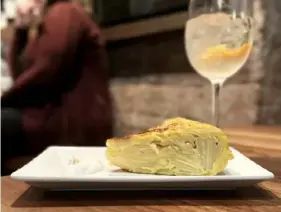  ?? Hal B. Klein/Post-Gazette ?? Potato tortilla served with sour cream at Barcelona Wine Bar in Downtown.