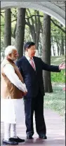  ?? AP/XINHUA/XIE HUANCHI ?? Indian Prime Minister Narendra Modi (left) and Chinese President Xi Jinping talk Saturday in a garden in Wuhan, China.