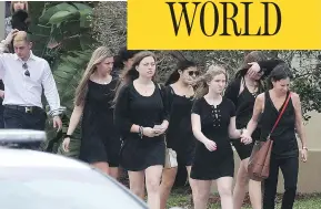  ?? JOEL AUERBACH / THE ASSOCIATED PRESS ?? Mourners leave the Church by the Glades in Coral Springs, Fla., on Thursday, where a funeral was held for football coach Aaron Feis, 37, who was among those killed at Marjory Stoneman Douglas High School on Valentine’s Day.