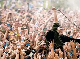  ?? BRIAN CASSELLA/CHICAGO TRIBUNE ?? Crystal Castles dives into the crowd while performing on the opening day of Lollapaloo­za in Grant Park in 2011.