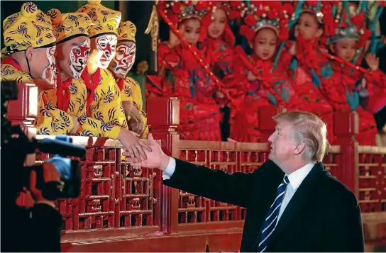  ?? PHOTO: REUTERS ?? President Donald Trump shakes hands with opera performers at the Forbidden City in Beijing, China.