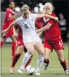  ??  ?? RICH Lam/getty Images American Amy Rodriguez, left, fights off Canada’s Kaylyn Kyle Sunday night during the 2012 CONCACAF Women’s Olympic qualifying tournament final in Vancouver. The U.S. won 4-0.