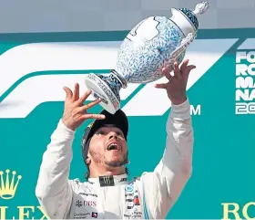  ?? Picture: AP. ?? Lewis Hamilton with the Hungarian GP trophy.