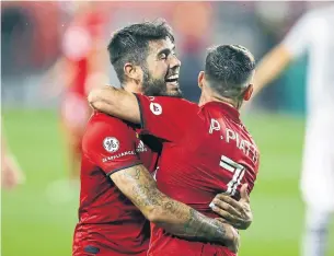  ?? VAUGHN RIDLEY GETTY IMAGES FILE PHOTO ?? Toronto playmaker Alejandro Pozuelo, seen hugging teammate Pablo Piatti, has scored in each of the past four games and notched the winner in three of them.