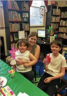  ??  ?? Kelly Borham is all smiles thanks to her sons Connor and David Borham, who stopped in the Prospect Park Library and made their mom a flower vase keepsake craft for Mother’s Day.