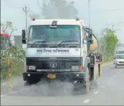  ?? SAKIB ALI/HT ?? A tanker sprays disinfecta­nt along a road in Raj Nagar Extension, from where two Covid-19 cases were reported.