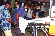  ??  ?? Police personnel stand as hospital staff take the body of Indian Bollywood actor Sushant Singh Rajput after he took his own life, into a hospital for post mortem report, in Mumbai.