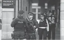  ?? ADRIAN DENNIS, AFP/GETTY IMAGES ?? Armed police secure the area across the road from the Palace of Westminste­r in central London on Thursday.