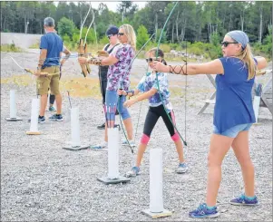  ?? NIKKI SULLIVAN/CAPE BRETON POST ?? Sarah Finkle, 12, in the front, shoots her arrow at the target while her 10-year-old sister, Hannah Finkle, gets ready to shoot again during an archery lesson on Aug. 27 at Highland Bow and Arrow near Wreck Cove in Victoria County.