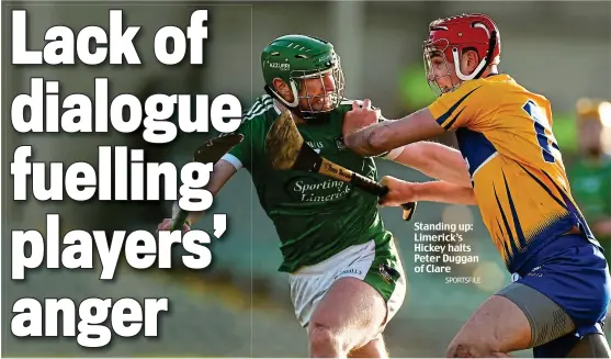  ??  ?? Standing up: Limerick’s Hickey halts Peter Duggan of Clare SPORTSFILE