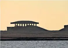  ??  ?? Dark past: the sun sets over one of the pagodas built as test laboratori­es at Orford Ness