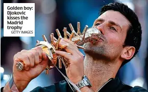  ?? GETTY IMAGES ?? Golden boy: Djokovic kisses the Madrid trophy