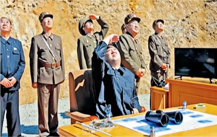  ??  ?? North Korean leader Kim Jong-un, seated, watching the successful launch of the interconti­nental ballistic missile in the north-west of the country. President Donald Trump responded: ‘Hard to believe that South Korea … and Japan will put up with this...