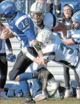  ?? For Montgomery Media / SUSAN KEEN ?? Pennridge’s Micah Stutzman tackles Quakertown’s Pat SanAngelo during Thursday’s Thanksgivi­ng Day action.