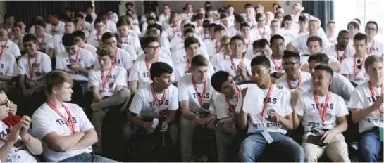  ?? APPLETV+/A24 ?? The eyes of Texas high school boys are on Chicago transplant René (front row, with jug) in a scene from the documentar­y “Boys State.”