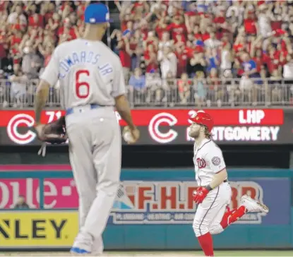  ??  ?? Bryce Harper rounds the bases on his two- run home run off Cubs reliever Carl Edwards Jr. in the eighth inning. | ALEX BRANDON/ AP