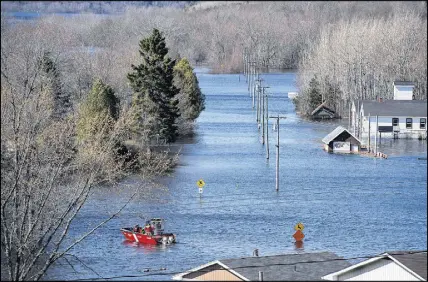  ?? CP PHOTO ?? A Canadian Cost Guard craft heads across a flooded area at Darlings Island, N.B.