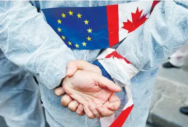  ?? FRANCOIS MORI / THE ASSOCIATED PRESS FILES ?? An activist demonstrat­es against the EU trade deal with Canada, known as CETA, in 2016. France’s ambassador to Canada, Kareen Rispal, said it is better to let Europeans see the benefits of the deal slowly instead of rushing into a debate about its merits before EU elections in the spring.