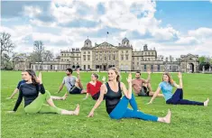  ?? ?? Home stretch: Lady Bella Somerset (in blue yoga pants) leads a yoga group at Badminton