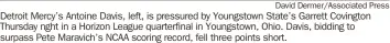  ?? David Dermer/Associated Press ?? Detroit Mercy’s Antoine Davis, left, is pressured by Youngstown State’s Garrett Covington Thursday nght in a Horizon League quarterfin­al in Youngstown, Ohio. Davis, bidding to surpass Pete Maravich’s NCAA scoring record, fell three points short.