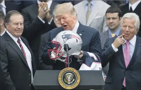  ?? Andrew Harnik Associated Press ?? PRESIDENT TRUMP with Patriots coach Bill Belichick, left, and owner Robert Kraft in 2017. Trump played to white nationalis­m.