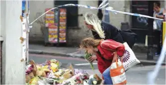  ??  ?? LONDON: People leave flowers at a police cordon in the London Bridge area of London yesterday in tribute to victims of terror attack on London Bridge and the nearby Borough Market. —AFP