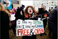  ?? AP PHOTO BY CAROLYN KASTER ?? In this 2017 file photo, Lindsay Chestnut of Baltimore holds a sign that reads “I like My Internet Like I Like my Country: Free & Open” as she protests near the Federal Communicat­ions Commission (FCC), in Washington where the FCC was scheduled to meet...